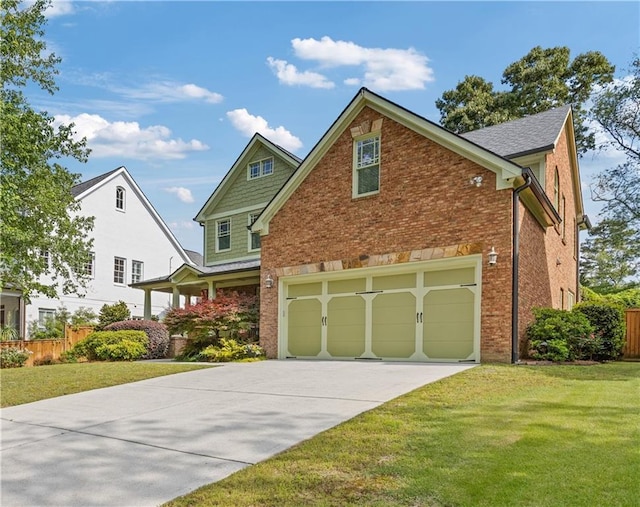 view of front of property featuring fence, an attached garage, concrete driveway, and a front yard