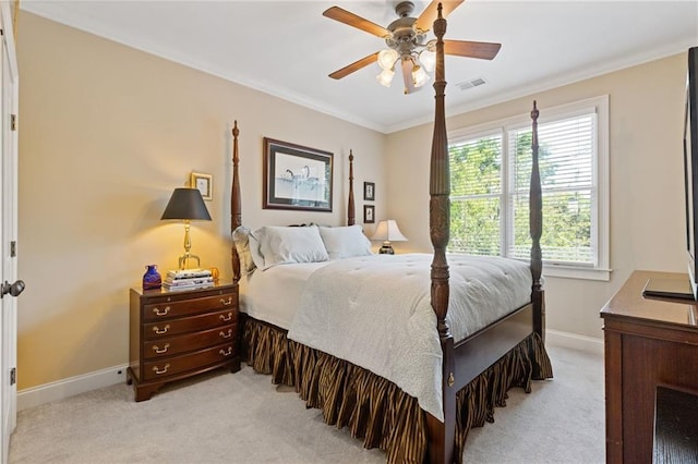 bedroom featuring ceiling fan, light colored carpet, visible vents, baseboards, and ornamental molding