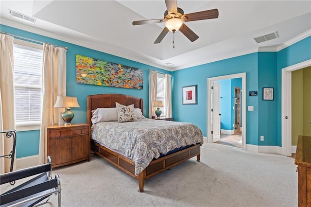 carpeted bedroom with visible vents, a ceiling fan, baseboards, and crown molding