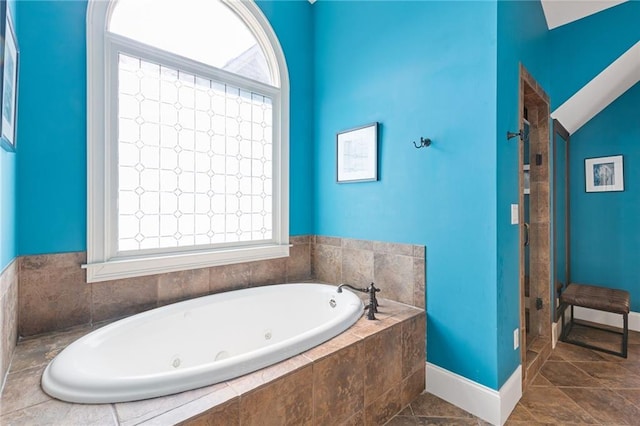 full bathroom featuring plenty of natural light, a whirlpool tub, and a shower stall