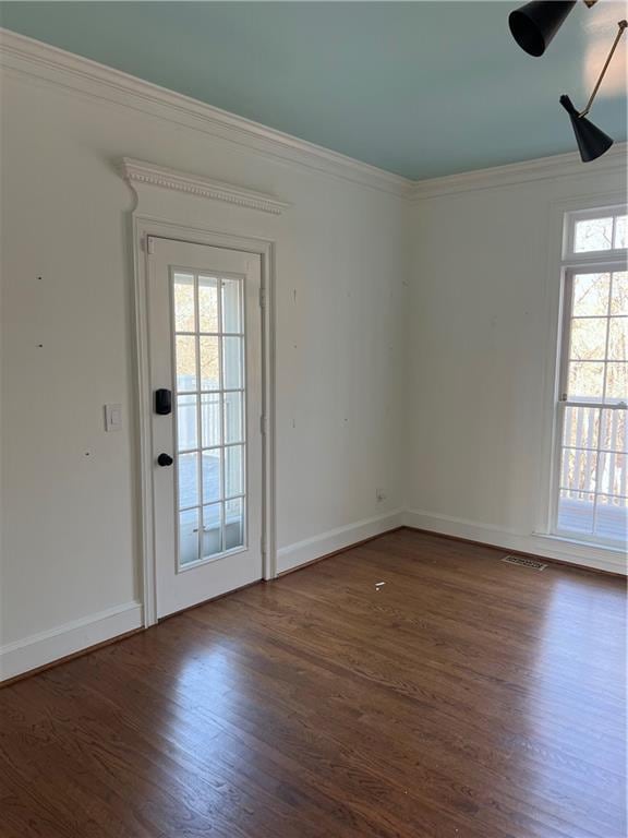 unfurnished room featuring crown molding and dark hardwood / wood-style floors