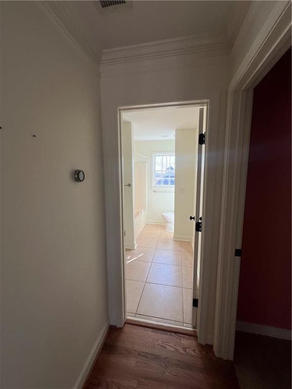 hall featuring ornamental molding and light wood-type flooring