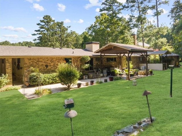 view of property's community with a lawn and a patio area