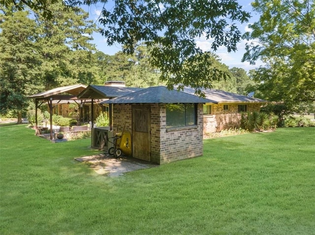 view of outdoor structure featuring a lawn