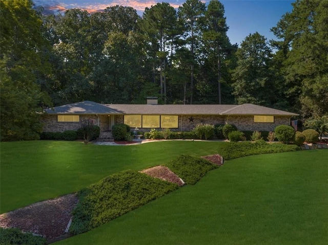 ranch-style home featuring a yard