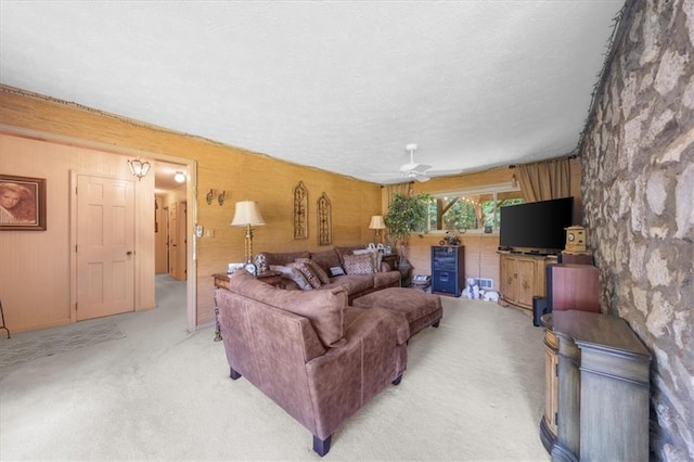 carpeted living room with ceiling fan