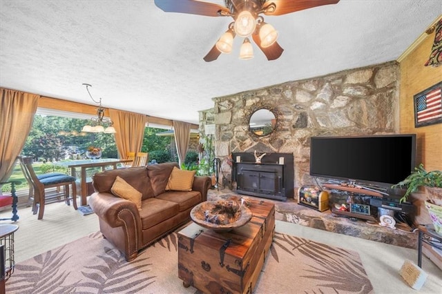 living room featuring a textured ceiling, light colored carpet, and plenty of natural light