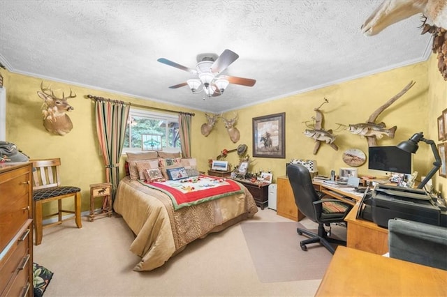 carpeted bedroom with a textured ceiling, ornamental molding, and ceiling fan