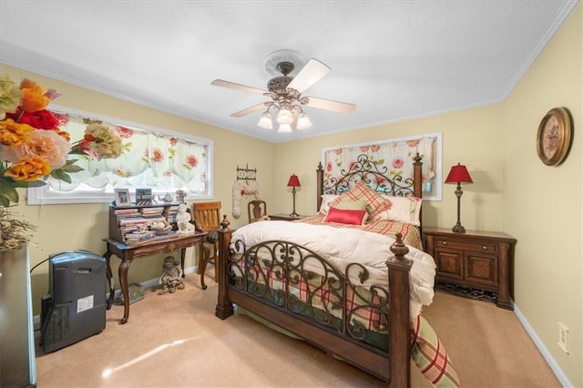 carpeted bedroom with ceiling fan and crown molding