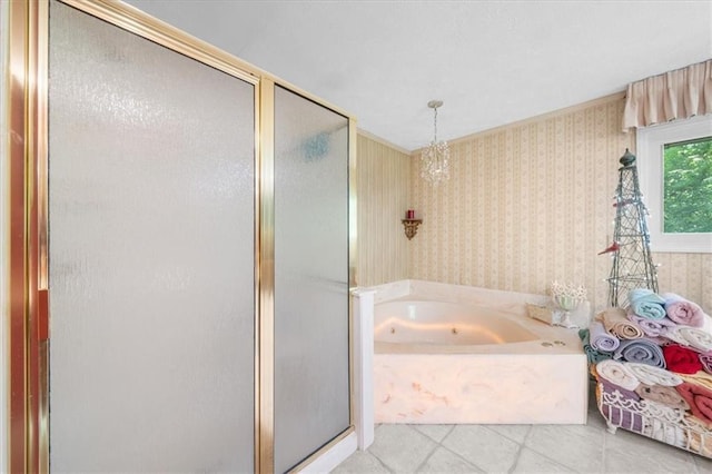 bathroom with independent shower and bath, decorative columns, and a notable chandelier