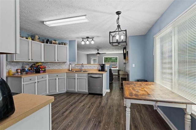 220 Brookstone Trl, Braselton, GA 30517 - kitchen featuring stainless steel dishwasher, dark wood finished floors, a peninsula, light countertops, and a textured ceiling