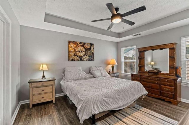 220 Brookstone Trl, Braselton, GA 30517 - bedroom featuring a raised ceiling, wood finished floors, a textured ceiling, and ceiling fan