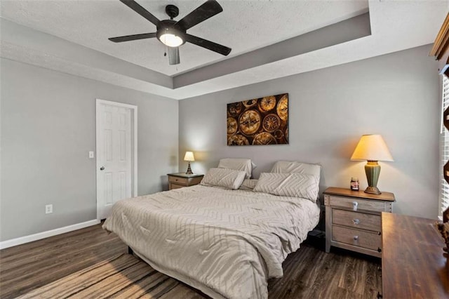 220 Brookstone Trl, Braselton, GA 30517 - bedroom featuring a raised ceiling, wood finished floors, a textured ceiling, and a ceiling fan