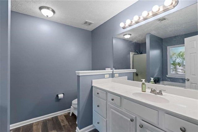 220 Brookstone Trl, Braselton, GA 30517 - full bath featuring a textured ceiling, wood finished floors, vanity, and a shower