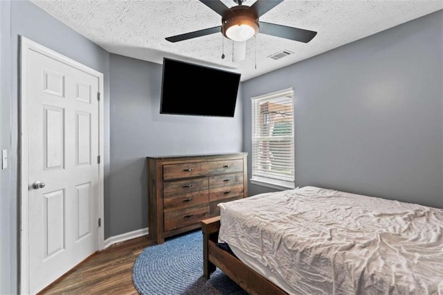 220 Brookstone Trl, Braselton, GA 30517 - bedroom with wood finished floors, a ceiling fan, and a textured ceiling