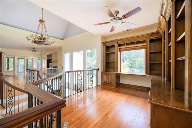 1006 Arbor Trce NE, Atlanta, GA 30319 - hallway with an upstairs landing, a chandelier, vaulted ceiling, light wood-type flooring, and ornamental molding