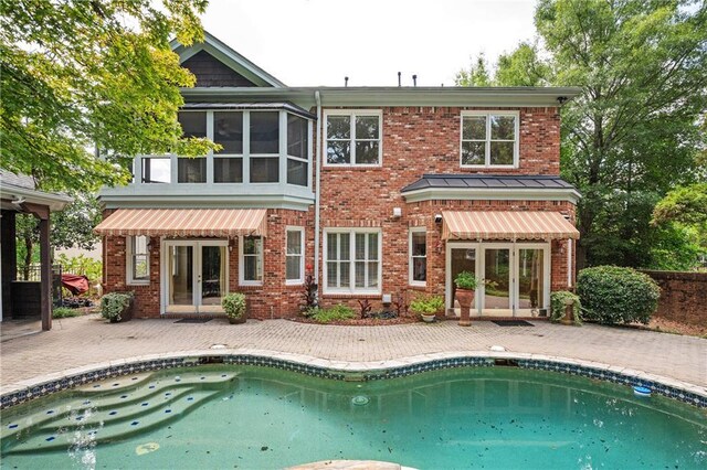 1006 Arbor Trce NE, Atlanta, GA 30319 - rear view of house with french doors, an outdoor pool, a patio area, and brick siding