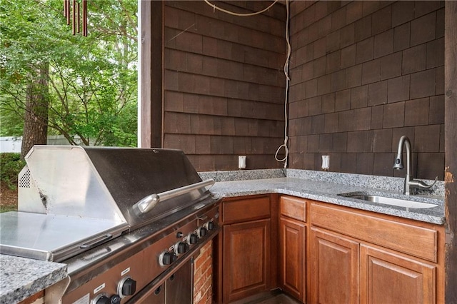 1006 Arbor Trce NE, Atlanta, GA 30319 - kitchen featuring light stone counters and brown cabinets