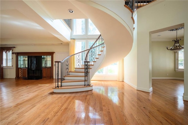 1006 Arbor Trce NE, Atlanta, GA 30319 - foyer entrance featuring stairway, a high ceiling, crown molding, wood finished floors, and a chandelier
