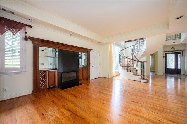 1006 Arbor Trce NE, Atlanta, GA 30319 - unfurnished living room featuring stairway, light wood-style flooring, ornamental molding, and a fireplace with flush hearth