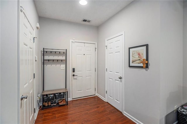 doorway with dark wood-type flooring