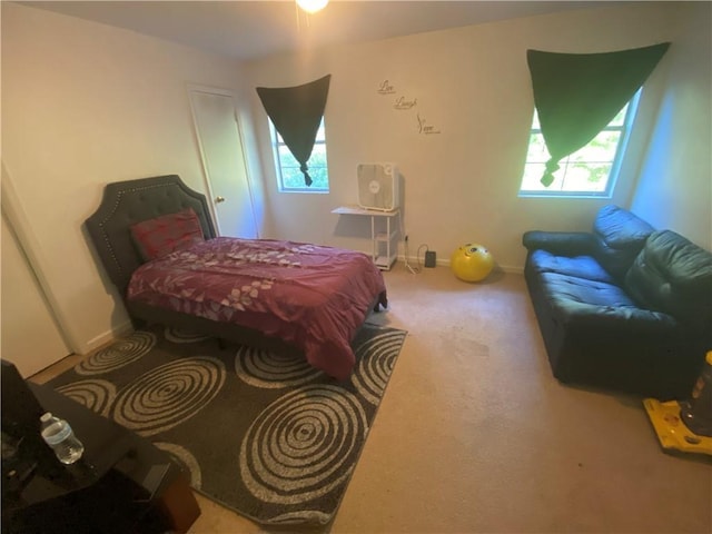 bedroom with carpet flooring and baseboards