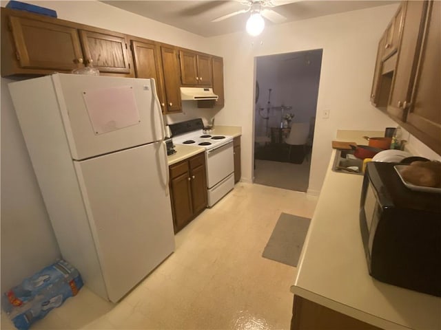 kitchen featuring white appliances, a ceiling fan, light floors, light countertops, and under cabinet range hood