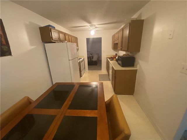 kitchen with white appliances, ceiling fan, and light countertops