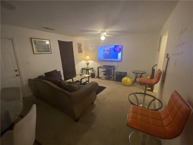 carpeted living room featuring a ceiling fan and visible vents