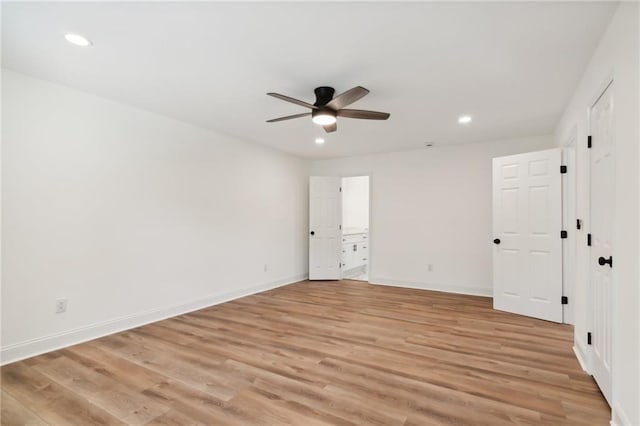 unfurnished bedroom featuring ceiling fan, light wood-type flooring, and connected bathroom