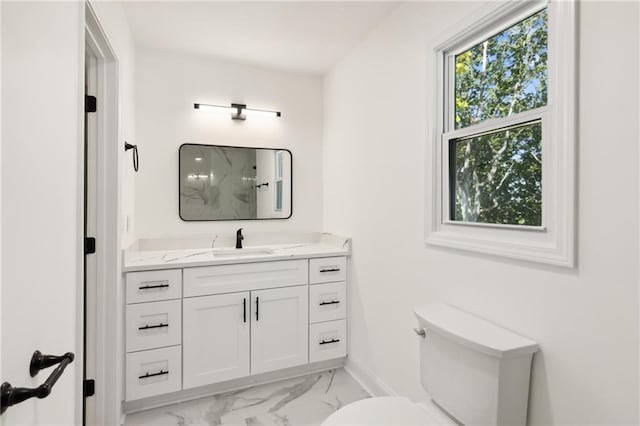 bathroom featuring walk in shower, vanity, and toilet