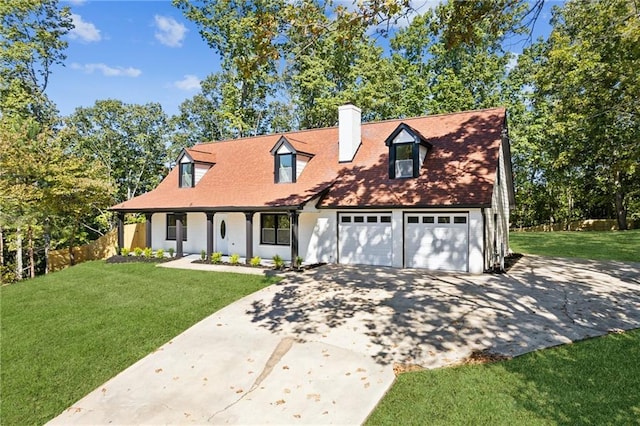 cape cod-style house featuring a garage and a front lawn