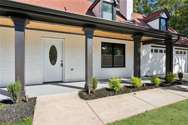 entrance to property with a porch and a garage