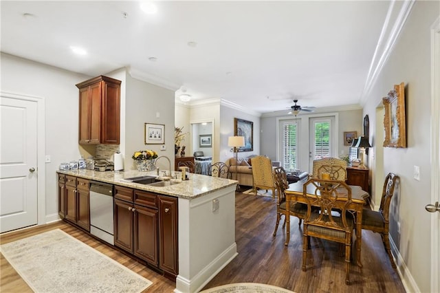 kitchen featuring kitchen peninsula, dark hardwood / wood-style flooring, light stone counters, stainless steel dishwasher, and sink