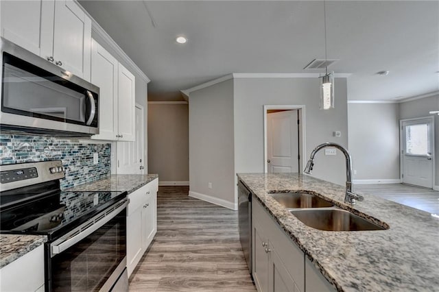4421 Fulson Dr, Lilburn, GA 30047 - kitchen featuring appliances with stainless steel finishes, a sink, baseboards, tasteful backsplash, and ornamental molding