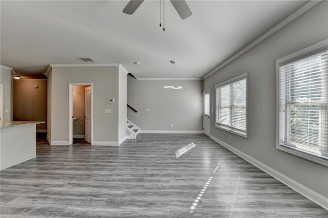4421 Fulson Dr, Lilburn, GA 30047 - unfurnished living room featuring crown molding, wood finished floors, stairs, a ceiling fan, and baseboards