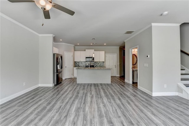 4421 Fulson Dr, Lilburn, GA 30047 - unfurnished living room featuring a ceiling fan, recessed lighting, stairs, baseboards, and ornamental molding
