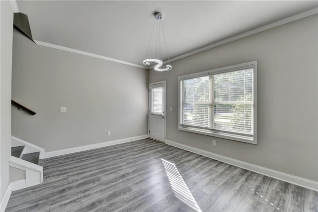 4421 Fulson Dr, Lilburn, GA 30047 - unfurnished dining area featuring crown molding, baseboards, wood finished floors, a chandelier, and stairs