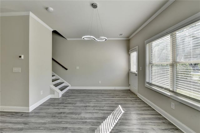 4421 Fulson Dr, Lilburn, GA 30047 - unfurnished dining area featuring a chandelier, ornamental molding, wood finished floors, stairs, and baseboards