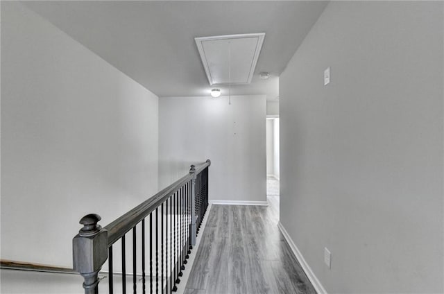 4421 Fulson Dr, Lilburn, GA 30047 - hallway with attic access, wood finished floors, an upstairs landing, and baseboards