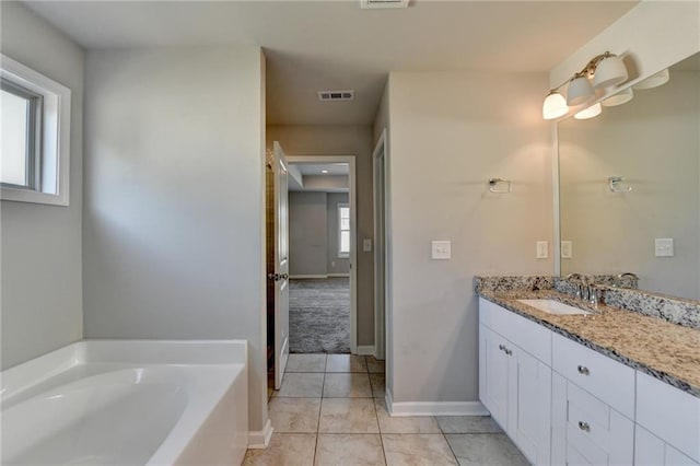 4421 Fulson Dr, Lilburn, GA 30047 - full bathroom featuring vanity, a bath, tile patterned floors, and baseboards