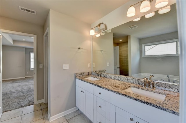 4421 Fulson Dr, Lilburn, GA 30047 - bathroom featuring double vanity, healthy amount of natural light, baseboards, and tile patterned flooring