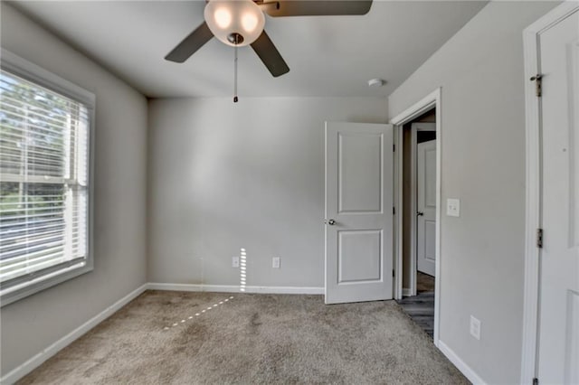 4421 Fulson Dr, Lilburn, GA 30047 - unfurnished bedroom with carpet, baseboards, and a ceiling fan