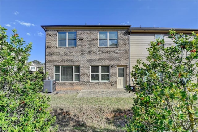 4421 Fulson Dr, Lilburn, GA 30047 - rear view of house with central AC, a patio, and brick siding