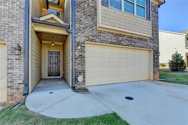 4421 Fulson Dr, Lilburn, GA 30047 - view of exterior entry featuring an attached garage, brick siding, and concrete driveway