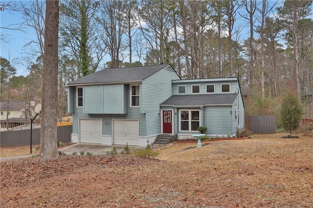 view of front of property with entry steps, a garage, a shingled roof, fence, and driveway