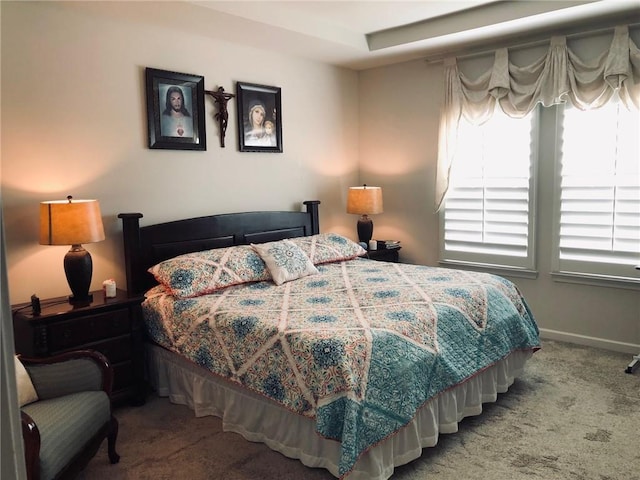 bedroom featuring carpet and baseboards