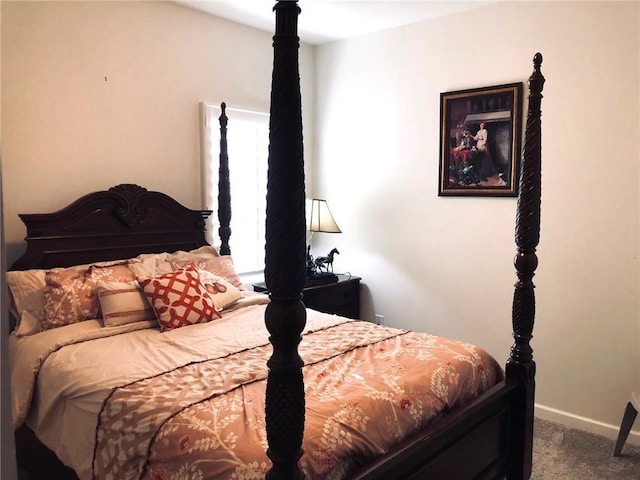 carpeted bedroom featuring baseboards