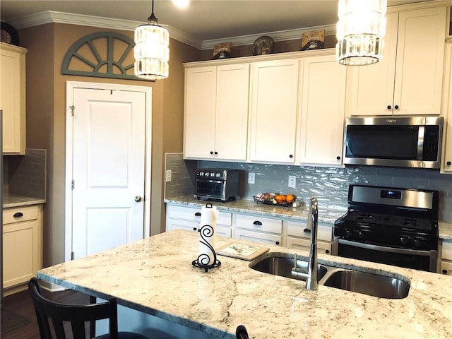 kitchen featuring backsplash, appliances with stainless steel finishes, crown molding, and a sink