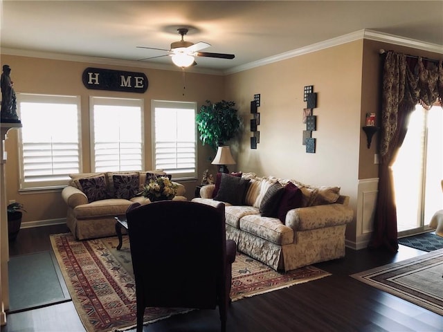 living area with plenty of natural light, crown molding, a ceiling fan, and wood finished floors